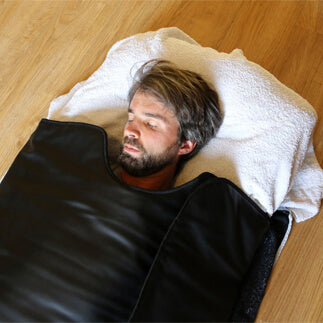 Man relaxing in sauna blanket
